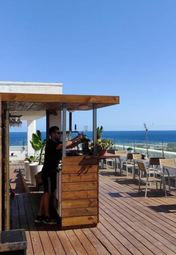 a man is sitting in a food stand on the beach at Eurohotel Diagonal Port in Barcelona