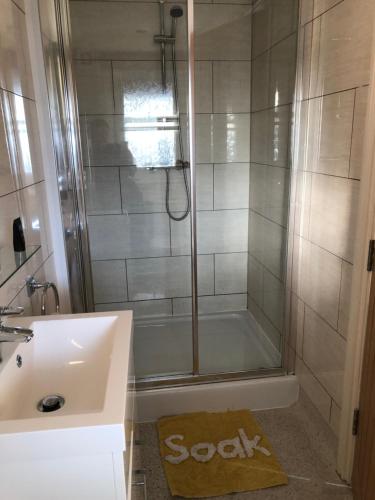 a bathroom with a shower and a sink and a tub at Queen Phillippa in Queenborough