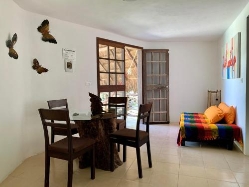 
a living room filled with furniture and a table at Villa Morena Boutique Hotel Ecoliving in Akumal
