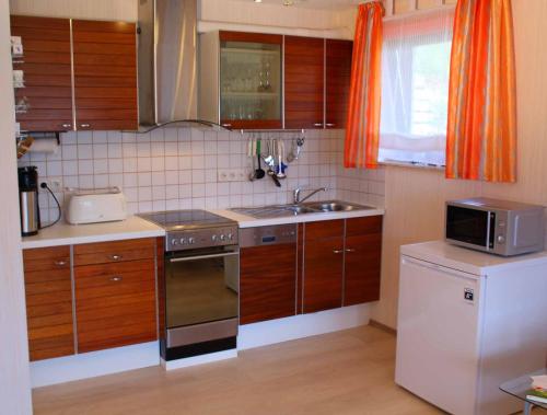 a kitchen with a sink and a stove top oven at Ferienwohnung Kling in Bischofsheim an der Rhön