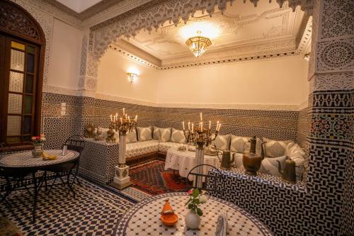 a living room with a couch and a table at Riad Dilar Fes & Spa in Fez