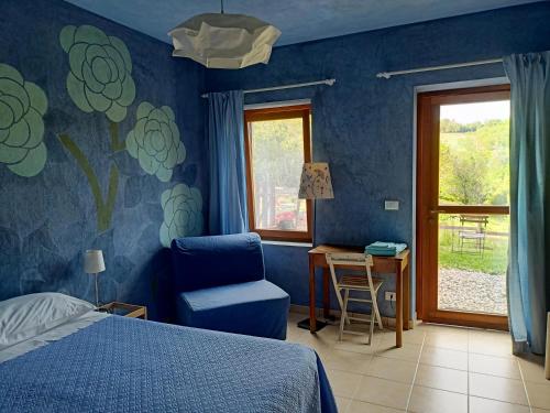- une chambre avec un lit, une chaise et un bureau dans l'établissement I Conti della Serva, à Cinzano