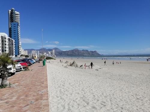 a group of people on a beach near the ocean at The Jade Somerset West in Cape Town