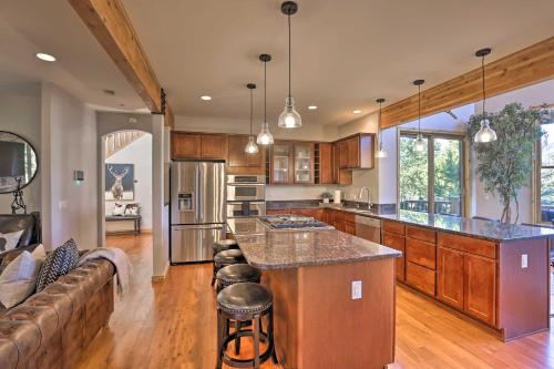 a large kitchen with a bar and a couch at Cabin with Game Room and Mtn Views in Silverthorne! in Silverthorne