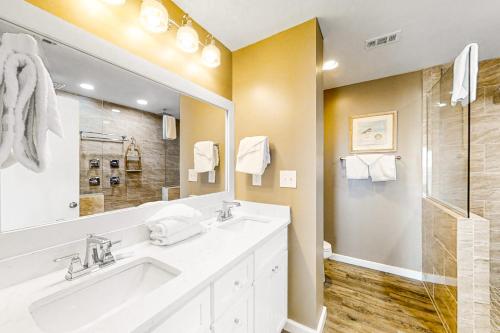 a bathroom with a white sink and a shower at Hakuna Matata in Gulf Shores