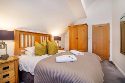 a bedroom with a large bed with two towels on it at Minster's Reach York city centre Apartments in York