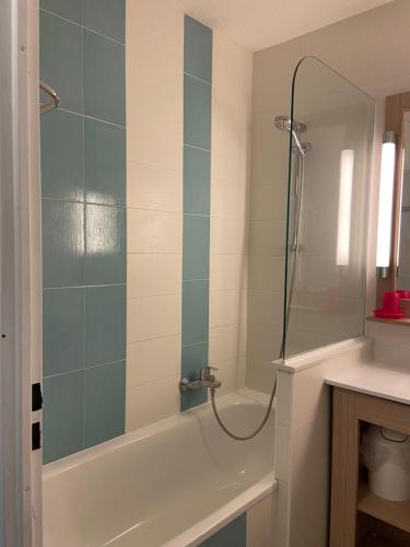 a bathroom with a shower with a tub and a sink at Domaine Valescure vue Piscine ou Pinede - Wifi in Saint-Raphaël