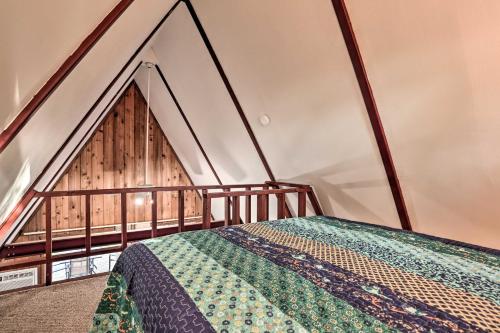a bedroom with a bed and a wooden wall at Cozy Toledo Bend A-Frame with Waterfront Views! in Burkeville
