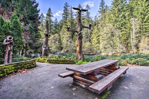 a wooden bench and a cross in a park at Enchanting Escape with Hot Tub, Decks and Views! in McKenzie Bridge