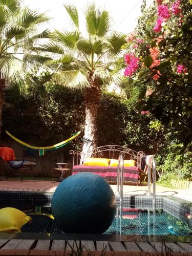 a swimming pool with a blue ball and a fountain at Janna d'Ifni in Sidi Ifni