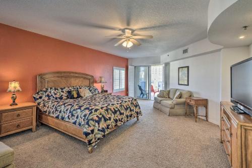a bedroom with a bed and a flat screen tv at Coastal Penthouse Steps to New Smyrna Beach! in New Smyrna Beach