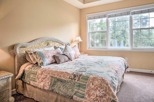 a bedroom with a bed and two windows at Bright and Airy Resort Condo Golf, Shop and Swim in North Myrtle Beach