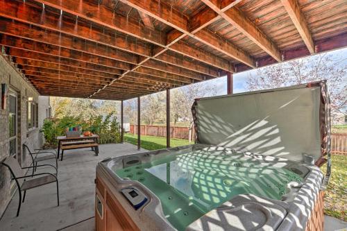 a hot tub on the patio of a house at Outdoor Enthusiasts Retreat with Hot Tub, Deck in Lander