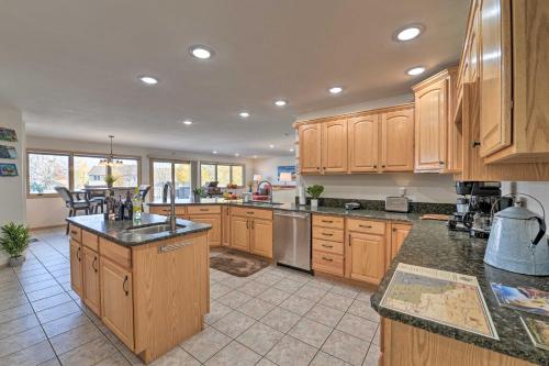 a large kitchen with wooden cabinets and a counter top at Outdoor Enthusiasts Retreat with Hot Tub, Deck in Lander