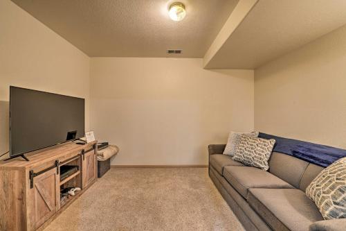 a living room with a couch and a flat screen tv at Outdoor Enthusiasts Retreat with Hot Tub, Deck in Lander