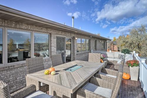 a patio with a wooden table and chairs at Outdoor Enthusiasts Retreat with Hot Tub, Deck in Lander