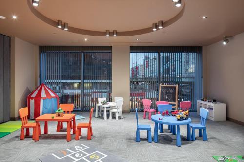 a room with tables and chairs and a play area at Melas Hotel Istanbul in Istanbul