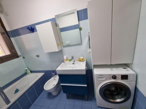 a bathroom with a washing machine and a washer at AMA Milano Intero appartamento Bicocca Zona 9 in Milan