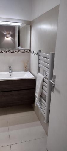 a bathroom with a sink and a bath tub at Sanary Côté Mer in Sanary-sur-Mer