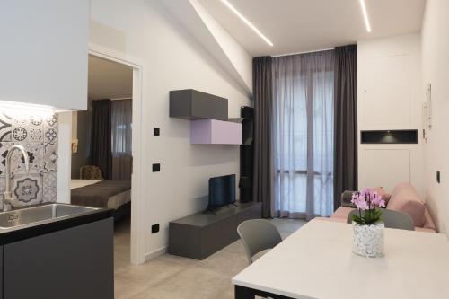 a kitchen and living room with a table and a living room at Amiata Suite in Abbadia San Salvatore