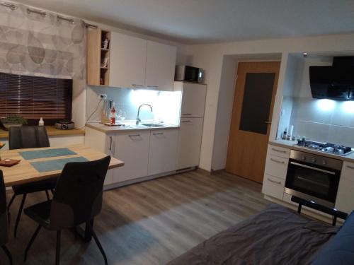 a kitchen and dining room with a table and a kitchen at Apartment Bon in Kobarid