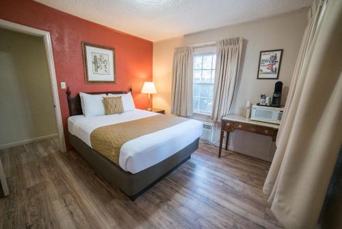 a hotel room with a bed and a window at Parry Lodge in Kanab