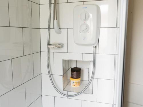 a shower with a soap dispenser in a bathroom at Pass the Keys Cozy two bed flat near Glasgow Airport & Paisley in Paisley