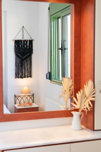 a mirror on a counter in a room at Villa Syriti in Skala