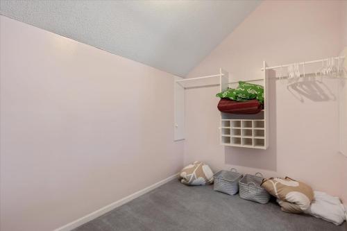 a room with white walls and a shelf with a plant at Private Dock Spacious Lakefront Home in Stover in Laurie
