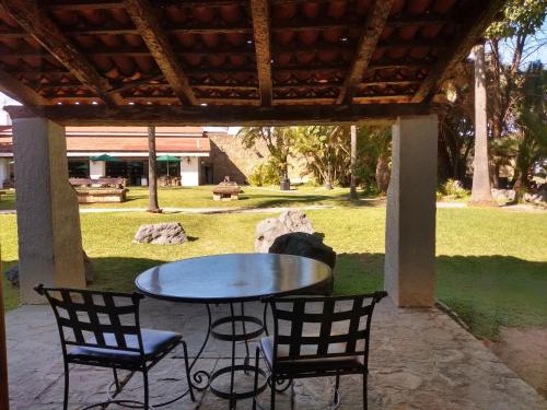 a table and chairs sitting under a covered patio at Radisson Hotel Tapatio Guadalajara Aeropuerto in Guadalajara