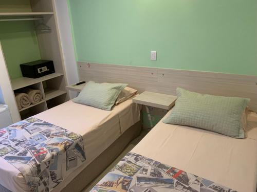 Un ou plusieurs lits dans un hébergement de l'établissement Grand Hotel Guarujá - A sua Melhor Experiência Beira Mar na Praia!