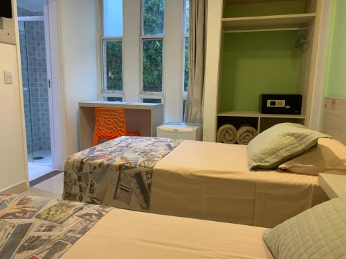 Un ou plusieurs lits dans un hébergement de l'établissement Grand Hotel Guarujá - A sua Melhor Experiência Beira Mar na Praia!