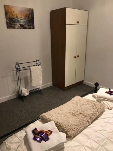 a bedroom with a bed and a closet and a cabinet at Rhos cottage Ruthin in Ruthin