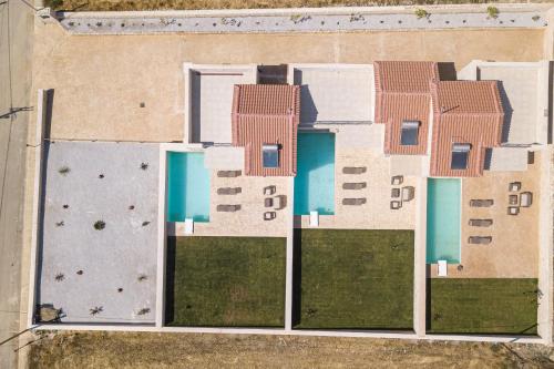 an aerial view of a building with a pool at Mythos villas in Damnoni