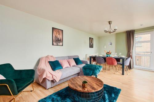 a living room with a couch and a table at The Sleek Nottingham Gem with Balcony - Sleeps 6 in Nottingham