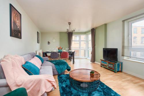a living room with a couch and a table at The Sleek Nottingham Gem with Balcony - Sleeps 6 in Nottingham