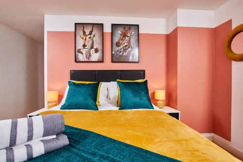 a bedroom with a large bed with orange walls at The Sleek Nottingham Gem with Balcony - Sleeps 6 in Nottingham