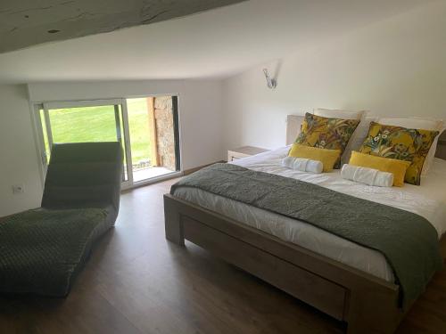a bedroom with a large bed with yellow pillows at CASARIOU Les Bernards Villa Grande bâtisse 12p avec cheminée bain nordique billiard piscine in Vaudevant