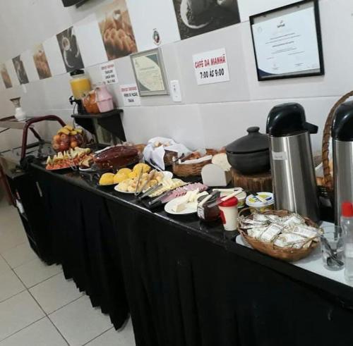 a buffet line with many different types of food at Pousada São Judas Tadeu in Cachoeira Paulista