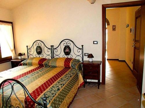a bedroom with a bed with a colorful blanket on it at R&B Tana delle Fate in Camugnano