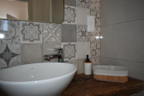 a bathroom with a white sink and a mirror at Casa da Cerca in Corte do Pinto