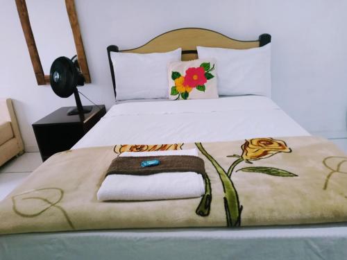 Ένα ή περισσότερα κρεβάτια σε δωμάτιο στο Minha casa pousada