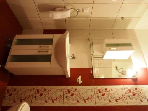 a bathroom with a sink and a mirror at Sea View Apartments in Sozopol