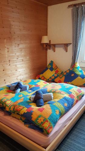 a bedroom with a bed with two stuffed animals on it at Landhaus Eifel in Demerath