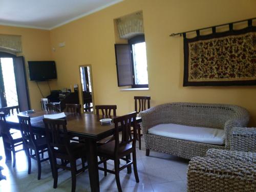 a living room with a table and chairs and a couch at Il casello della scala dei turchi in Realmonte