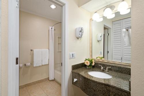 a bathroom with a sink and a mirror at Comfort Suites Paradise Island in Nassau