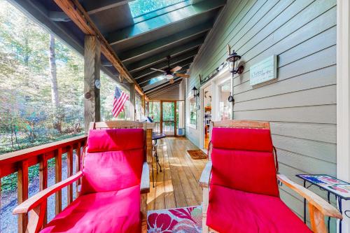 a porch with red chairs and an american flag at Clayton Haven in Clayton