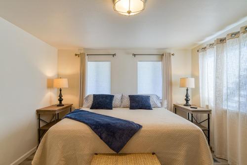 a bedroom with a bed with two lamps and two windows at Roadrunner's Roost in Twentynine Palms