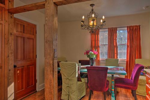 a dining room with a table and chairs and a chandelier at Cozy Adobe Casita 1 Mile to Santa Fe Plaza! in Santa Fe