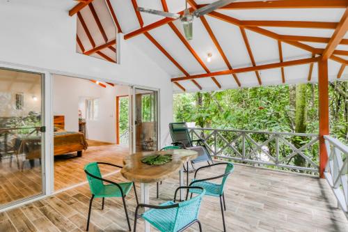 a living room with a table and chairs at Lost Pools Bungalow #Sloth in Uvita